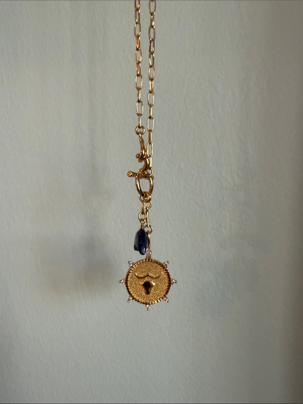 Gold Tone Sun Medallion Necklace with Black Accent